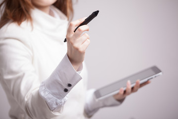 woman holding a tablet and stylus