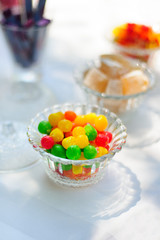Bright sweets in glass plate on the table