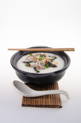 Traditional chinese pork porridge rice gruel served in claypot