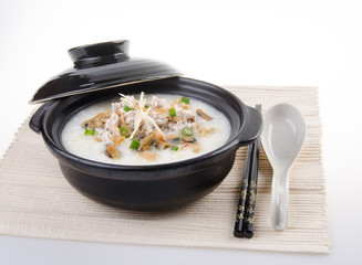 Traditional chinese pork porridge rice gruel served in claypot