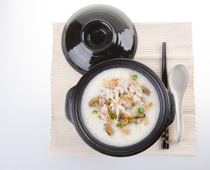 Traditional chinese pork porridge rice gruel served in claypot