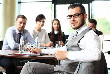 Businessman with colleagues in the background