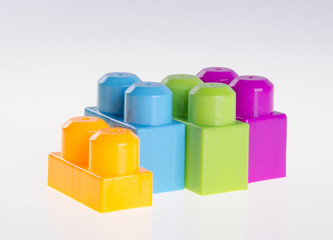 Plastic building blocks on background