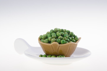 nuts or crispy coated green pea on the background.