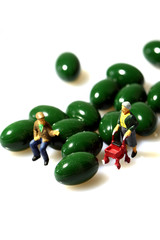 Miniature senior people medicine.
Miniature senior people with capsules isolated.