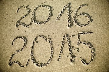 Happy New Year 2016 replace 2015 concept on the sea beach