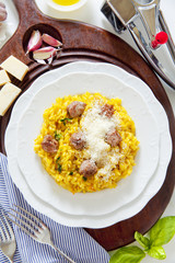 yellow saffron risotto with homemade sausage Milanese. Italian h