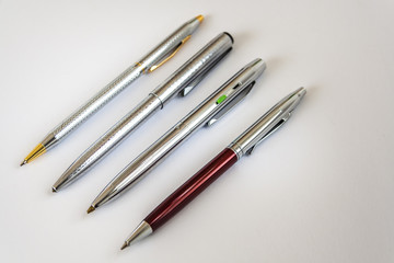Four Ballpoint Pens On White Background