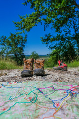 Obraz premium Wine Tourism-Pair of hiking shoes in the grass surrounded vineya