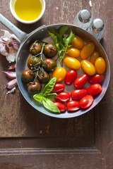 multicolor red and yellow cherry tomatoes in an aluminum pan for