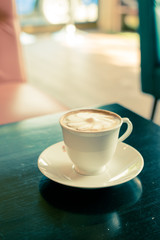 coffee cup on dark wooden table in coffee shop
