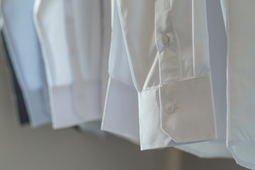 white shirts hanging on rack