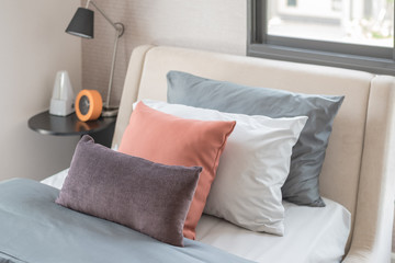 brown pillows on modern bed in bedroom