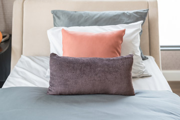 brown pillows on modern bed in bedroom