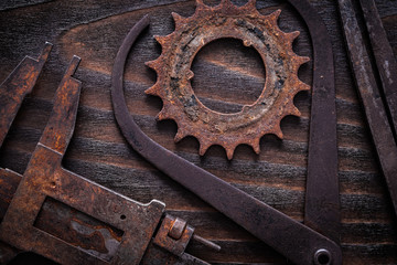 Set of rusty measuring calipers with cog- wheel on vintage dark 