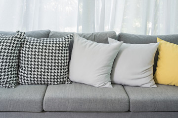 yellow and grey pillows on modern sofa