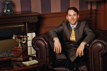 Businessman sitting in a leather executive chair.