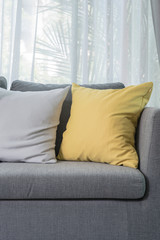 yellow pillow on grey sofa in modern living room