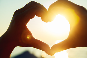 Heart of the hands against the sky

