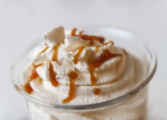 Coffe cocktail with caramel in glass cup close
