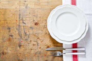 empty plate with cutlery on a wooden background. space for writi