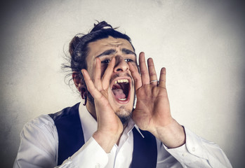 Angry young businessman screaming