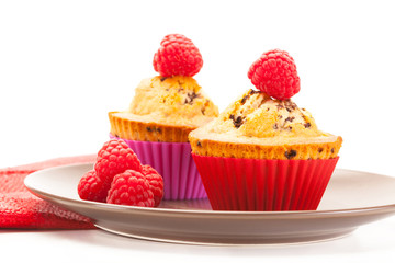 Tasty cupcakes with raspberries
