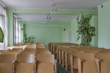 Vintage empty classroom with wooden chairs