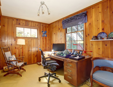 Traditional Home Office With Wood Panel Walls.