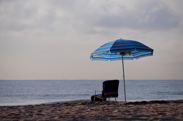 Lone beach chair and umbrella