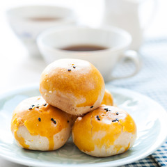 Chinese pastry moon cake with cup of tea