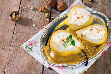 Delicious dessert with pears, sliced halves and curd cream on a
