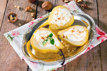 Delicious dessert with pears, sliced halves and curd cream on a