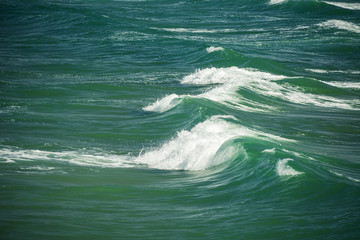 Sea waves splashing through the summer day