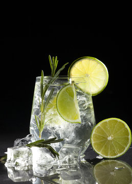 Gin And Tonic Cocktail With Lime Over Black Background.