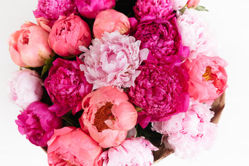 Close-up rich bunch of peonies and tea roses on white background