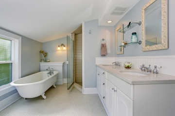 All white luxury master bathroom with vintage bathtub.