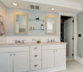 All white luxury master bathroom with vintage theme.