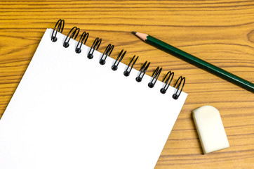 Blank paper and pencil on the wooden table