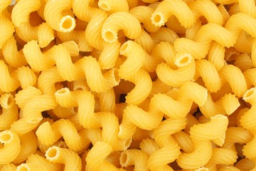Full background of dry uncooked cavatappi pasta 