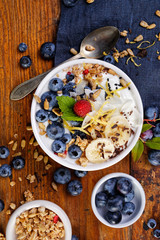 Natural yogurt with fresh organic blueberries, bananas and muesli