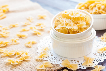 Bow tie pasta in mason jar on wooden board