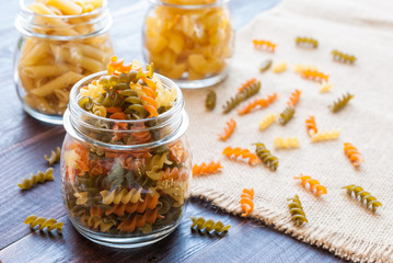 Bow tie pasta in mason jar on wooden board