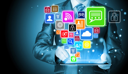 Business man using tablet PC with social media icon set