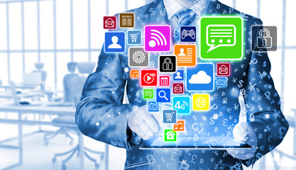 Business man using tablet PC with social media icon set