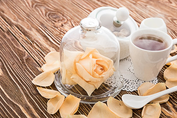 Tea cups with teapot on old wooden table