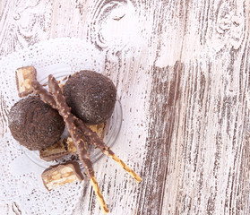 Cupcake with chocolate on wooden background