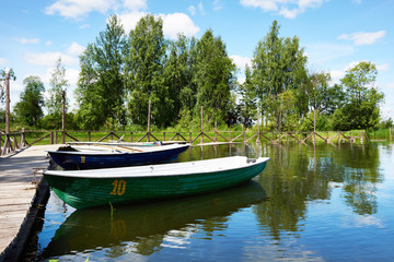 Naklejka na ściany i meble Landscape with pier of pleasure boats on Lake Valdai