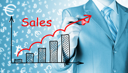 business man drawing graph of sales