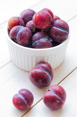 Sweet plums on wooden background
